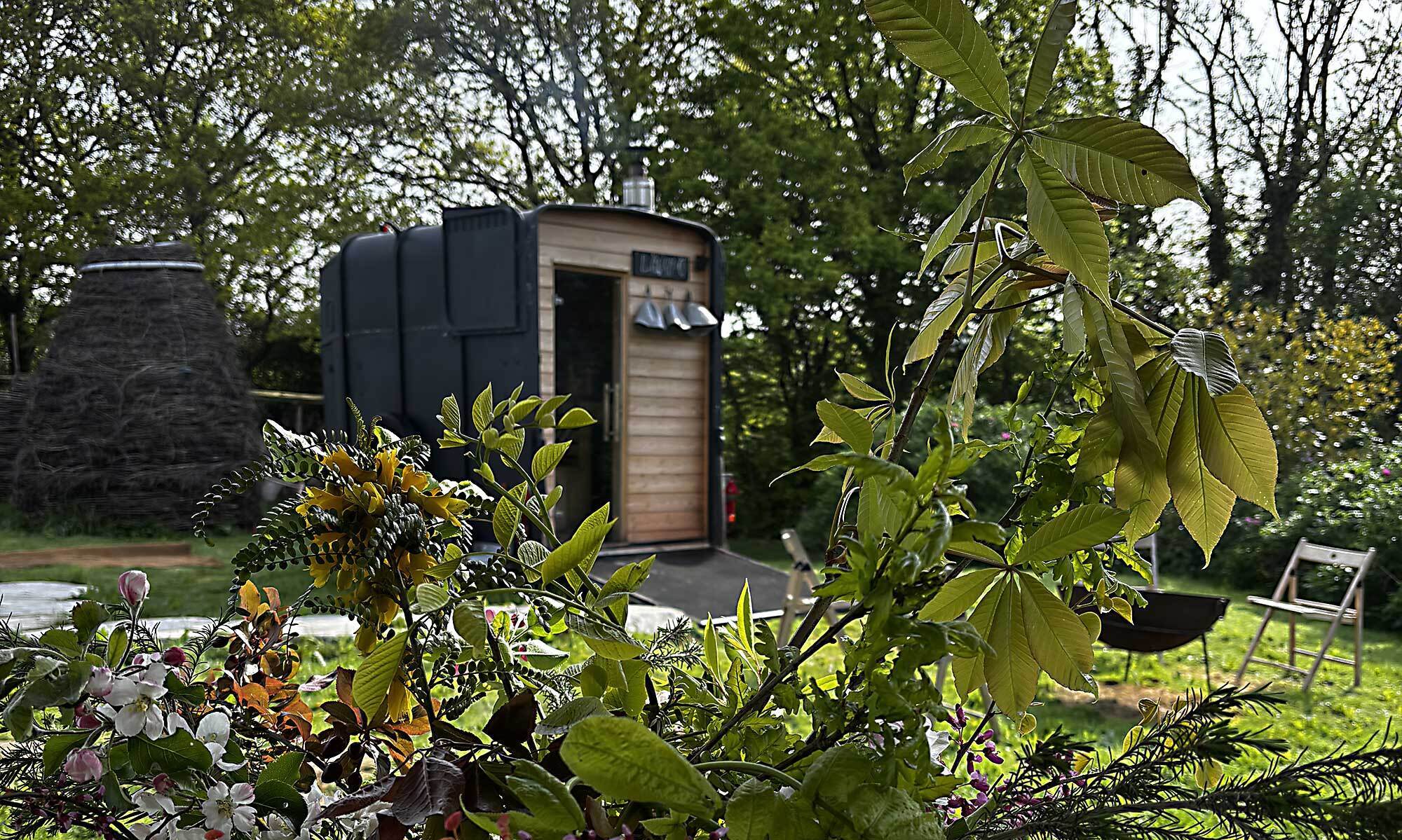 LogJam Sauna horse-box trailer in the cider orchard at Hammond's Wood, Catsfield, East Sussex
